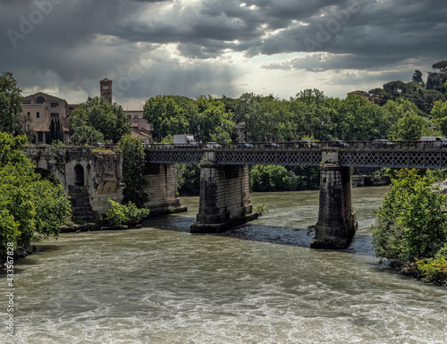 Rome Italy  old bridge on Tiber river under dramatic cloudy sky