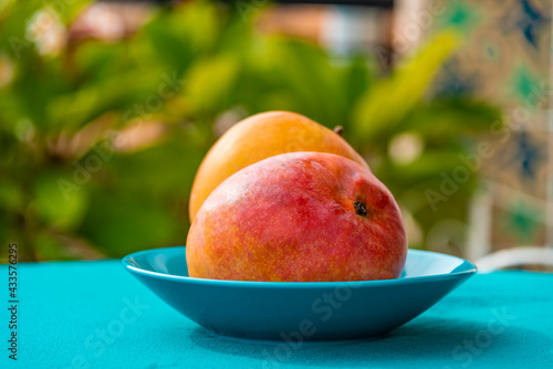 Closeup view of two mango fruits on a table