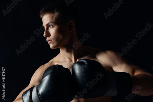 sport guy in boxing gloves close-up portrait black background  © SHOTPRIME STUDIO