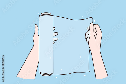 Packing things, copy space and mockup concept. Female hands using roll of transparent plastic cling film for packaging food on blue background vector illustration  photo