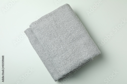 Clean folded towels on light gray background, top view