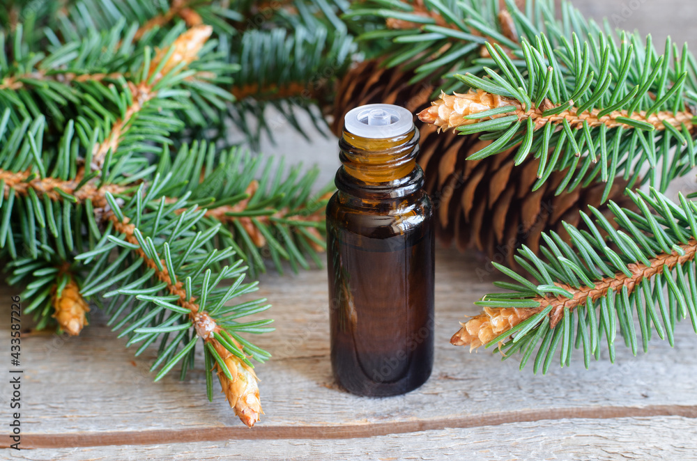 Small bottle with essential fir oil (extract, tincture, infusion). Old wooden background. Aromatherapy, spa and herbal medicine concept. Copy space. Small bottle with essential fir oil (extract, tincture, infusion). Old wooden background. Aromatherapy, spa and herbal medicine concept. Copy space.