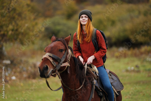 cheerful woman hiker ride a horse fun travel mountains © SHOTPRIME STUDIO
