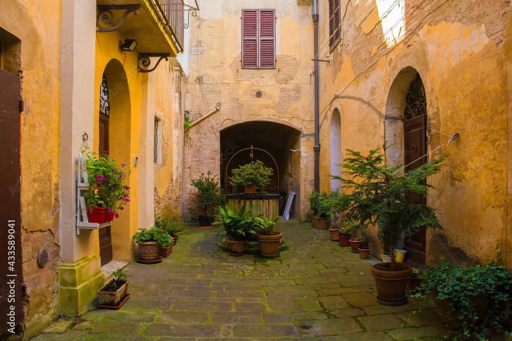 A residential courtyard in the historic medieval village of Buonconvento, Siena Province, Tuscany, Italy
