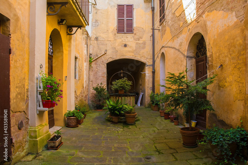 A residential courtyard in the historic medieval village of Buonconvento, Siena Province, Tuscany, Italy 