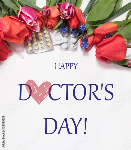 Flowers and pills with inscription Happy Doctor's Day on white. Square greeting card photo