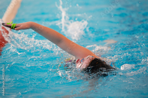 Child athlete swims in the pool. Swimming section. © Светлана Лазаренко