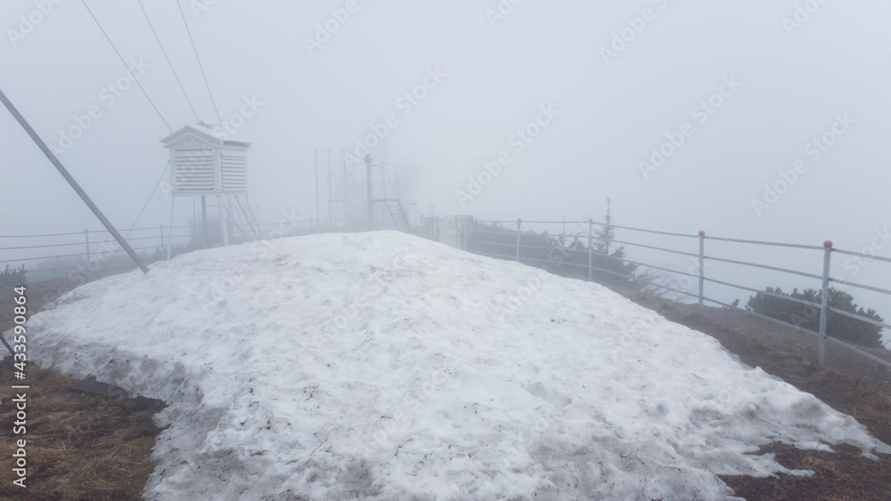 weather station and big pile of snow melting. fog landscape, Romania