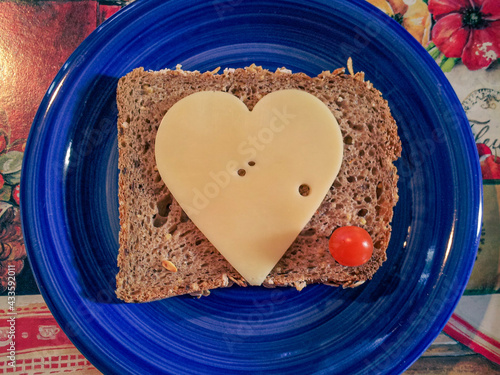Cheese love, heart, slice on bread on a blue plate, sandwich, whole grain food, healthy diet, calcium rich sustenance, emmental, edam, gouda