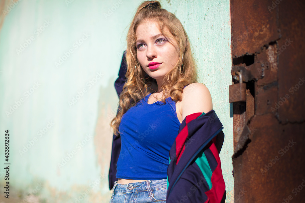 Beautiful girl in the style of the 90s in bright clothes. Beautiful girl in the style of the 90s in bright clothes.
