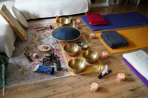 Sound healing set up with yoga mats and many instruments like RAV drum  monochord  guitar  tibetan singing bowls  cymbals  monochord  sansula.