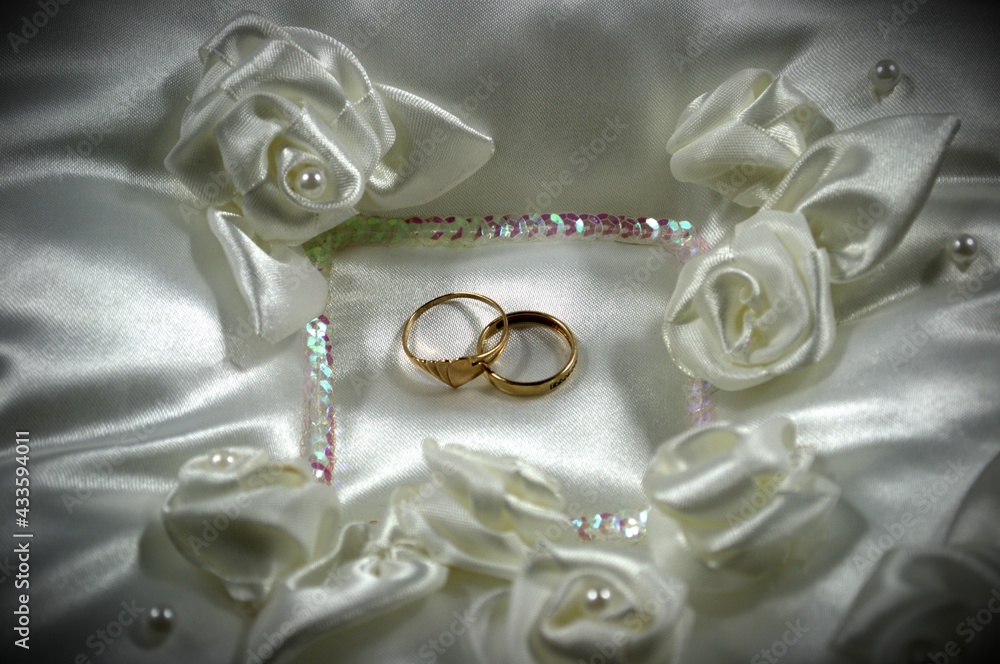 Wedding rings on a white pillow. Vignetting effect Wedding rings on a white pillow. Vignetting effect