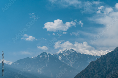 Clouds above the snow covered peak of the Himalayan mountain range at Manali in Himachal Pradesh, India