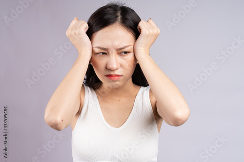 Asian woman suffering from headache