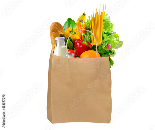 Paper bag full of different groceries on white background