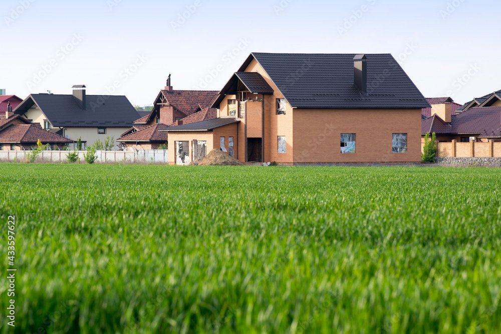 Fresh green grass near newly builded house