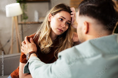 Young woman having a problem. Husband comforting his sad wife