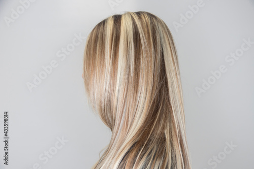 Side view of strait hair with highlights. Soft focus