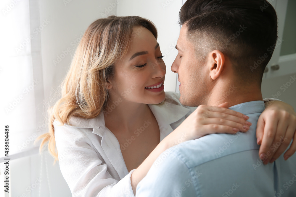 Lovely couple enjoying time together in kitchen at home