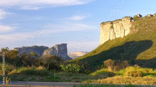 Trucks passing in front of Morro do Pai Inacio and Canyons, Chapada Diamantina, Bahia, Brazil.