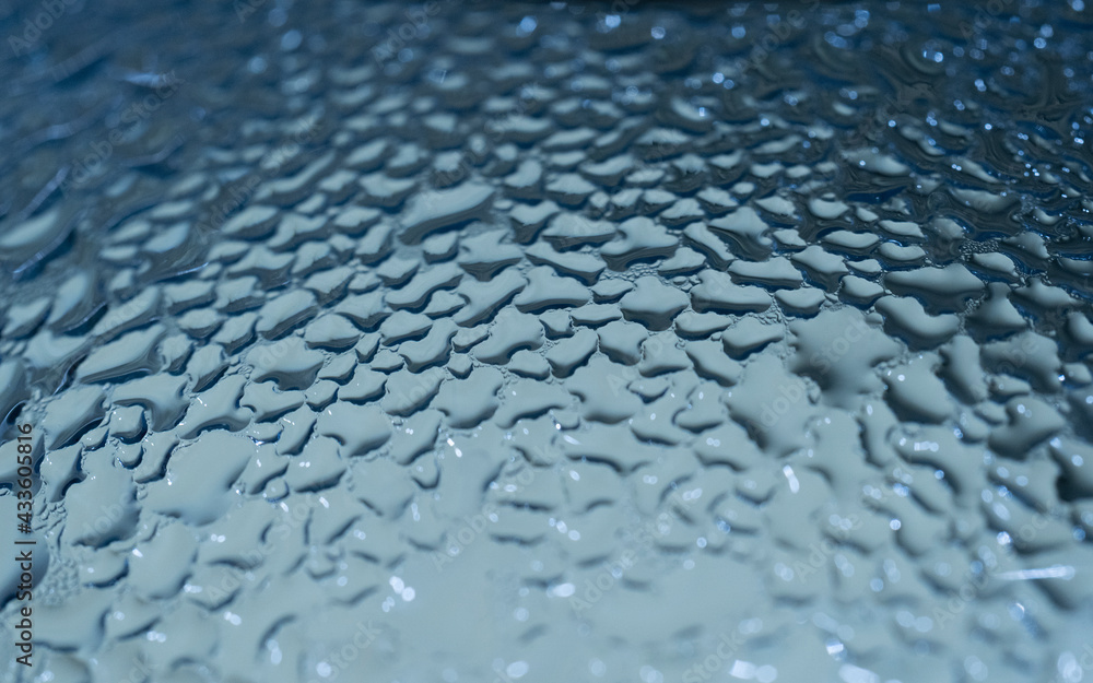 Drops of water on a blue color background. Selective focus Drops of water on a blue color background. Selective focus