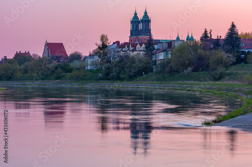 Poznan Cathedral on the island of Ostrow Tumski and Warta river at pink sunrise, Poznan, Poland.