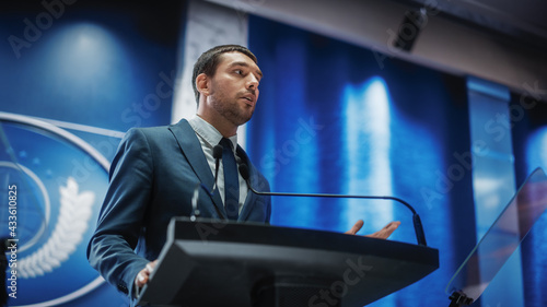 Photos Portrait of an Young Organization Representative Speaking at Press Conference in Government Building