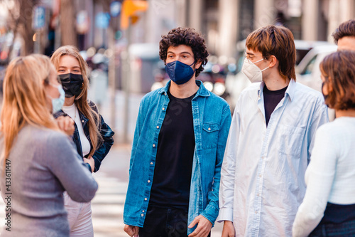 Group of people wearing protective face masks conversating