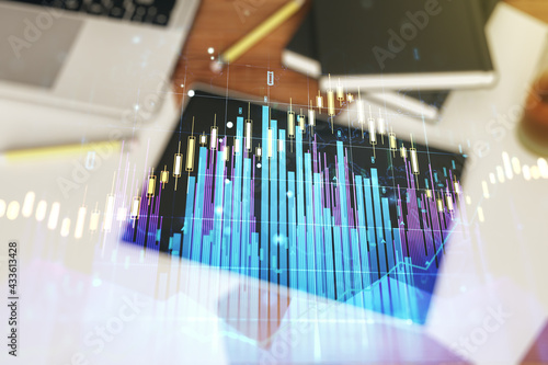 Multi exposure of abstract creative financial graph and modern digital tablet on background, top view, forex and investment concept