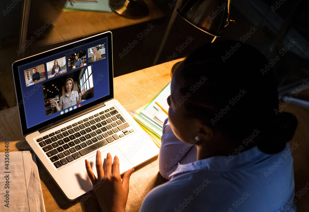African american businesswoman sitting at desk using laptop having video call
