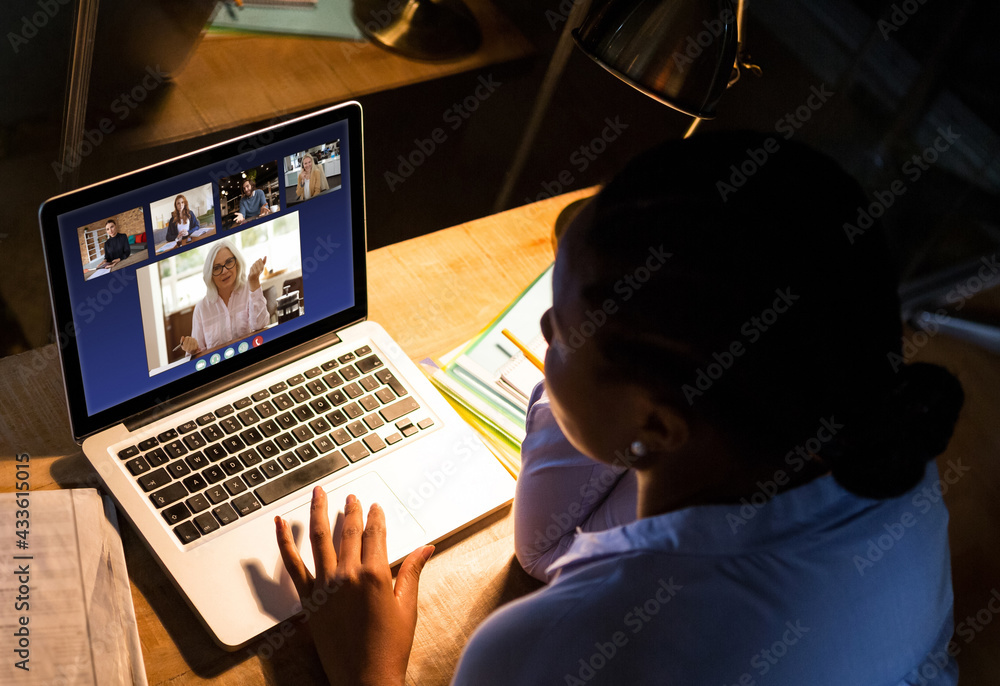 A businesswoman sitting at desk using computer having video call with female colleague A businesswoman sitting at desk using computer having video call with female colleague