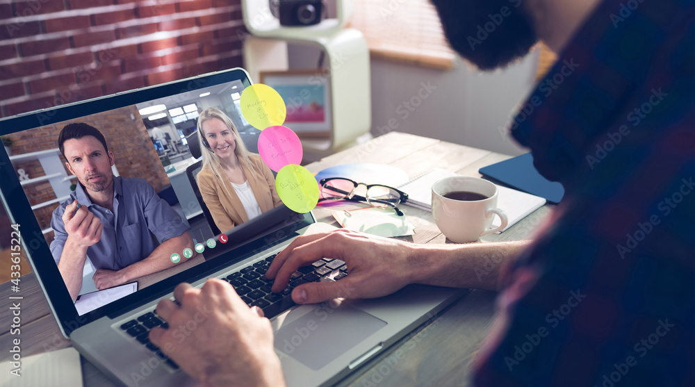 Caucasian man siting at desk, using laptop, having video call with coworkers