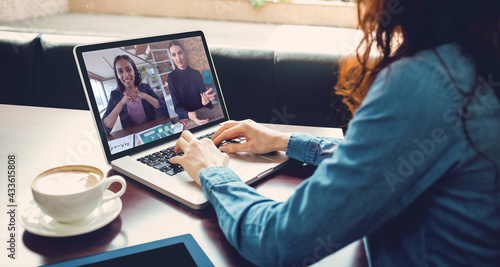 Caucasian woman having video call with coworkers