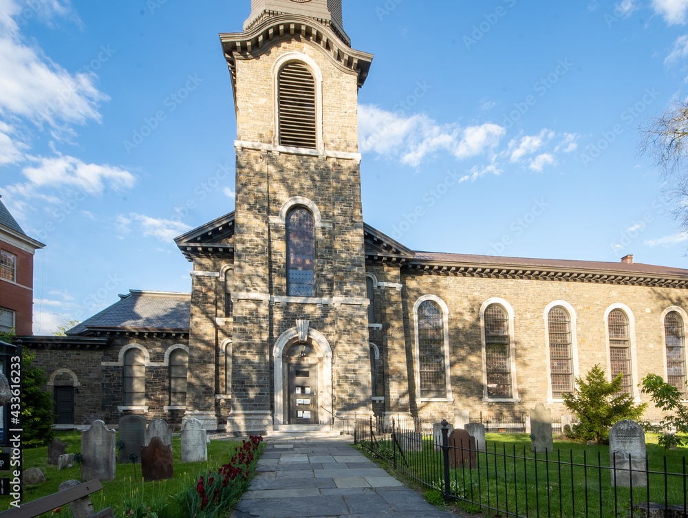 Fototapeta premium Kingston, NY - USA- May 12, 2021: The Old Dutch Church, a 19th-century bluestone church and cemetery located on Wall Street in the Kingston Stockade District.