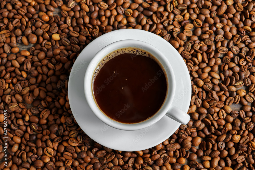Horizontal banner with a cup of coffee and coffee beans. Top view. Copy space. Espresso or Americano in a cup. Coffee beans background Horizontal banner with a cup of coffee and coffee beans. Top view. Copy space. Espresso or Americano in a cup. Coffee beans background