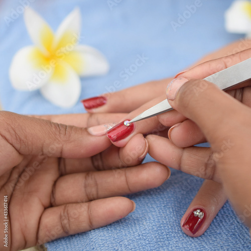 girl get nail art by manicurist