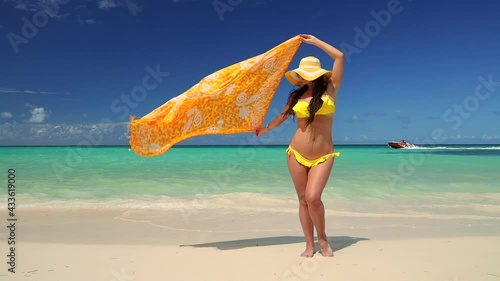 Beautiful girl in bikini relaxing on tropical island beach with turquoise water and white sands. Punta Cana, Dominican Republic photo