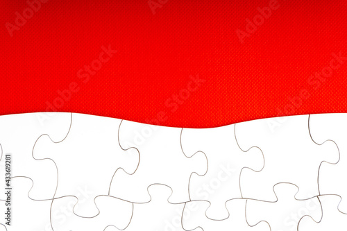 Red jigsaw puzzle pieces on red background. Copy space and business concept