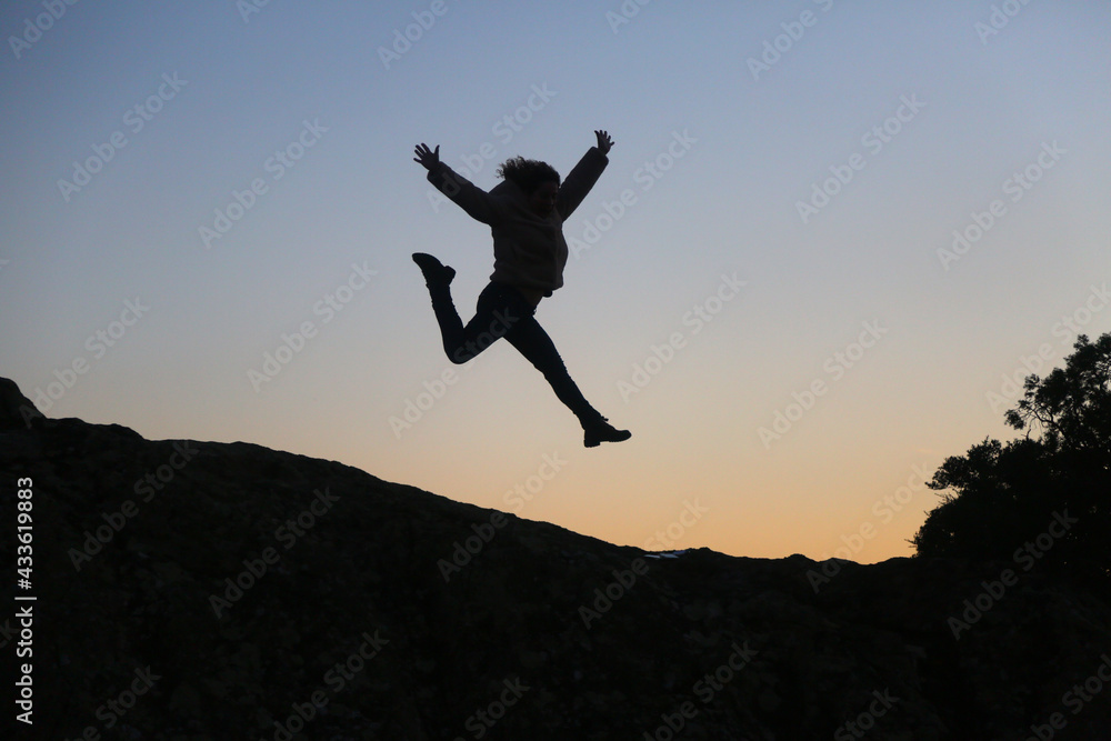 silhouettes of people in the mountain with sunrise sky background