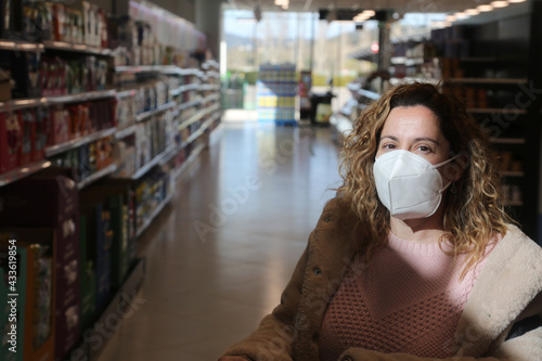 buying in the supermarket with face mask as protection