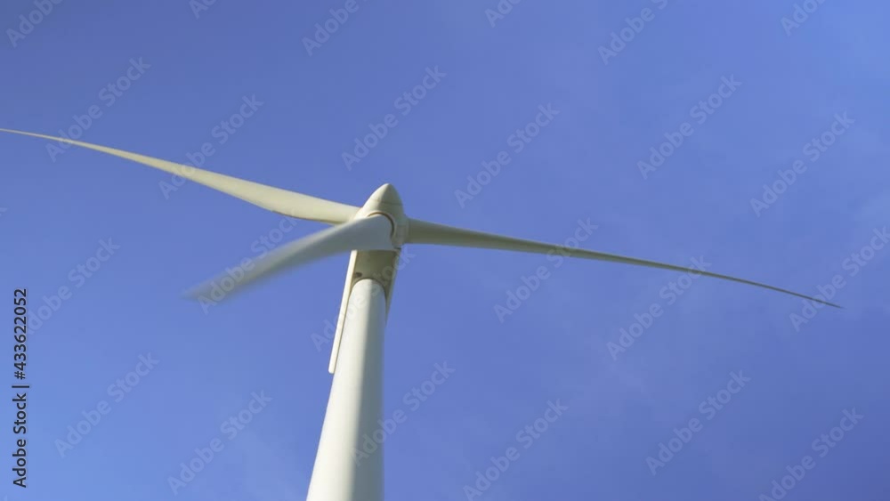 Windmill tower with sky on the background at wind farm generating green electricity - Wind alternative energy concept Windmill tower with sky on the background at wind farm generating green electricity - Wind alternative energy concept