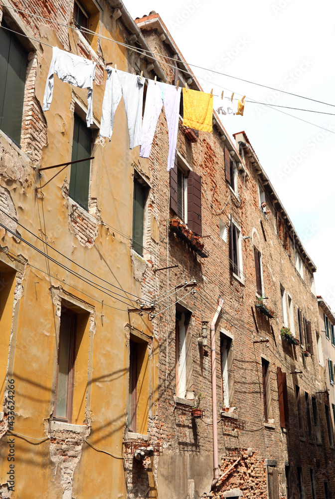 clothes hanging out to dry in an Italian city with houses