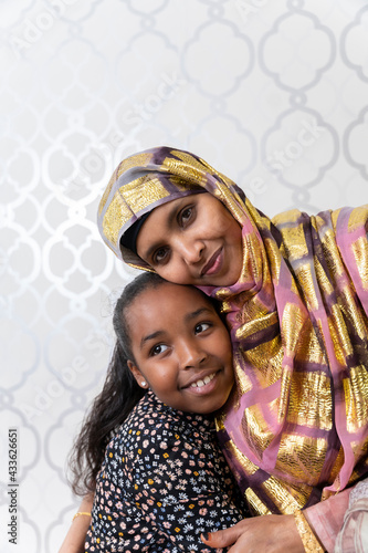 Принти на полотні A Black Muslim woman with her young niece