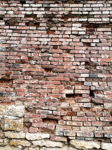 Old crumbling brick wall as an abstract