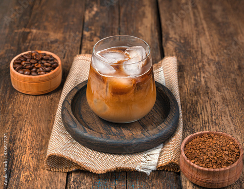 Iced coffee on a wooden background. A refreshing, invigorating drink.