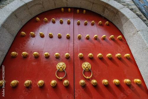 The first door knocker with animal heads on the Dahong Gate of an ancient Chinese building photo