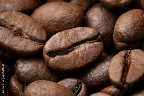 Brown roasted coffee beans close up full frame as a background 