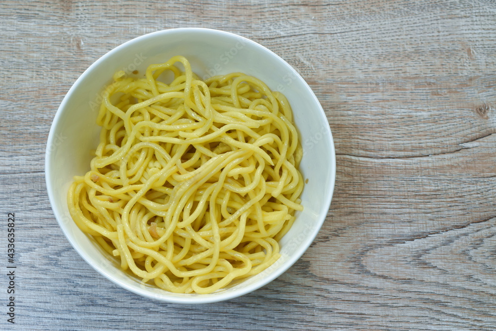 fried Yakisoba yellow Japanese noodles with oil on white bowl