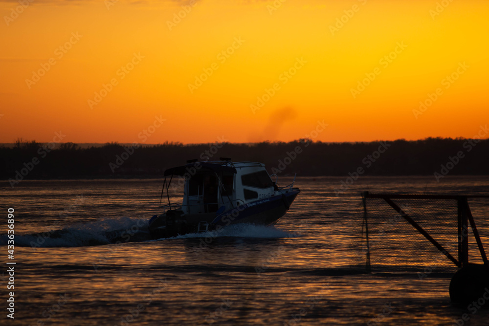 Ship on sunset, bright orange sun, big river Ship on sunset, bright orange sun, big river