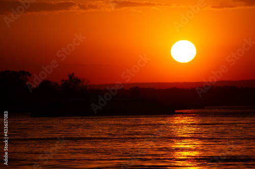 orange sunset by the water  the sun in the sky 